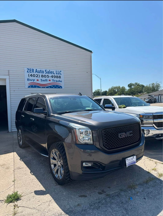 GMC SUV parked in front of ZER Auto Sales building